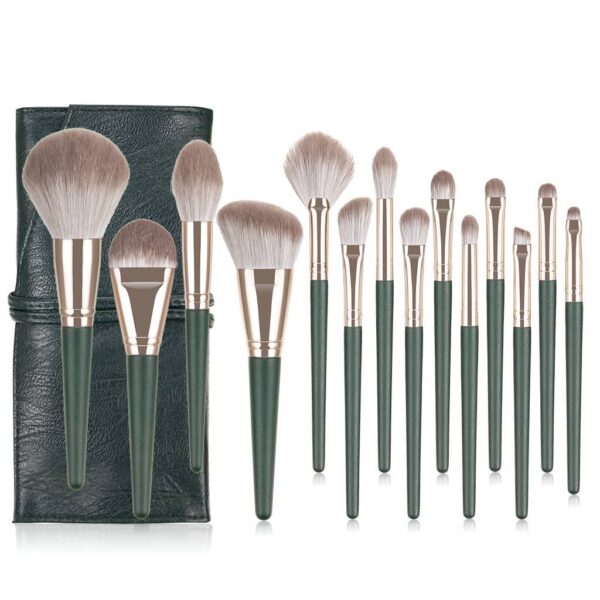 Complete 14-piece professional makeup brush set with forest green handles and matching leather travel roll